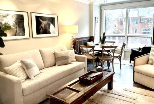 a living room with a couch and a table at Designer Unit -Center of Town of Telluride, steps to Gondola and town park in Telluride