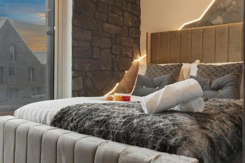 a large bed in a room with a large window at House of Suede by UNIS Estates in Sheffield