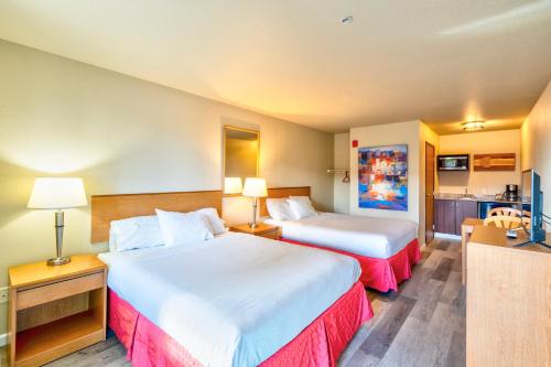 a hotel room with two beds and a kitchen at City Inn in Westminster