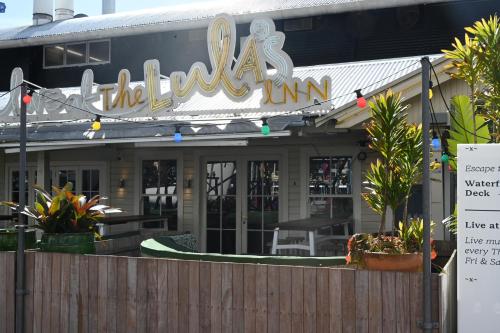 a restaurant with a sign that reads theolis inn at Luxurious & Spacious Living with Breathtaking Views in Auckland
