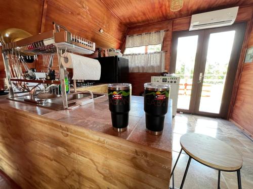 a kitchen with two drinks on a counter at Cabaña 787 in Lares