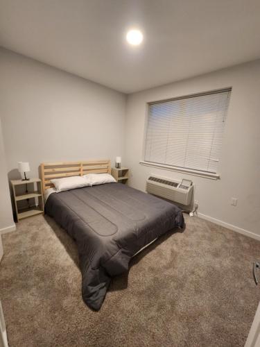 a bedroom with a large bed and a window at Stylish Modern 2BR Mins to NYC! in Jersey City