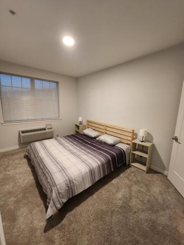 a bedroom with a large bed and a window at Stylish Modern 2BR Mins to NYC! in Jersey City