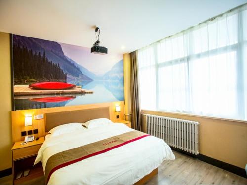 a bedroom with a large bed and a large window at Thank Inn Plus Hotel Shandong Liaocheng Railway Station in Liaocheng