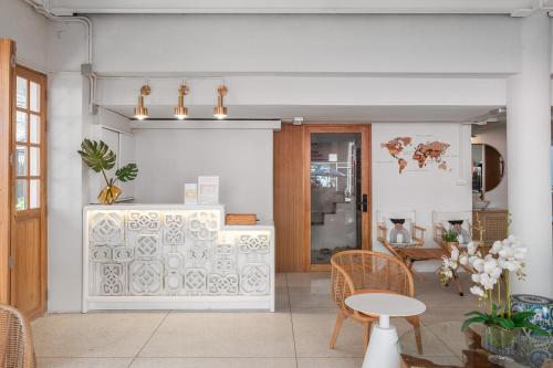 a room with a table and chairs and a counter at Unplugged at Bangrak Design Hostel in Bangkok