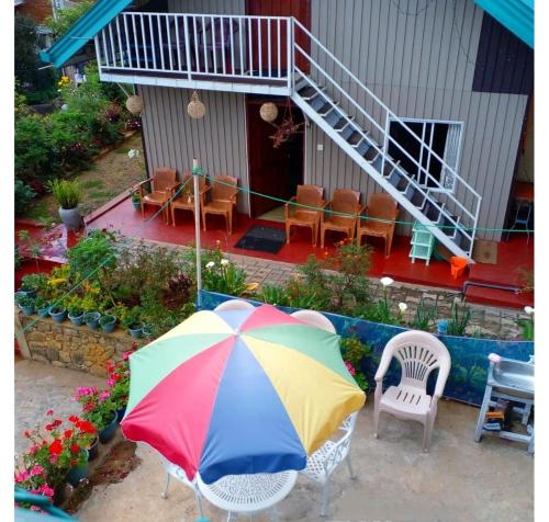 a colorful umbrella sitting in front of a house at Townside Lodge in Nuwara Eliya