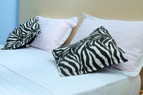 Una cama o camas en una habitación de Triple Tee Gardens & Accomodation