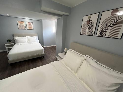 a bedroom with a bed with white sheets and pillows at Cozy basement in Brampton in Brampton