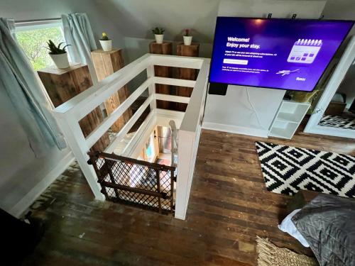 a room with a white fence and a tv at Private NE Portland Guesthouse in Portland