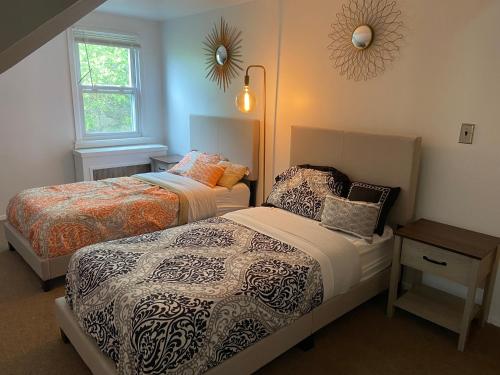 a bedroom with two beds and a window at BBQ, Beats, Hot Tub Retreat in Baldwin