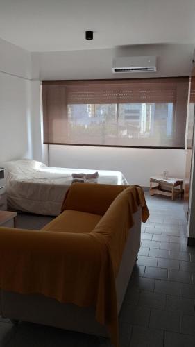a bedroom with a bed and a large window at Quilmes departamentos in Quilmes