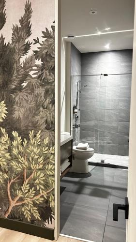a bathroom with a shower and a toilet at Luxury Mountain Retreat with Spa Near Mont Tremblant in La Conception