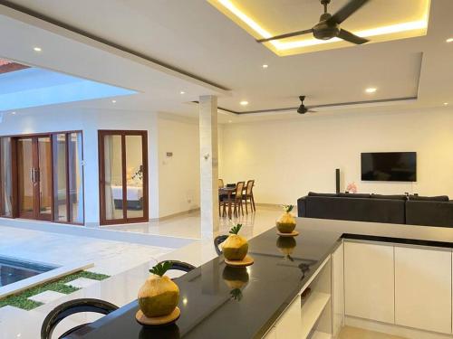 a kitchen and living room with a table with fruit on it at Villa Akmali Umalas 2BR with Private Pool & Jacuzzi in Canggu