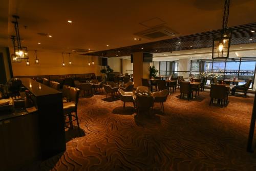 a restaurant with tables and chairs and a bar at Ardenhills Suites in Manila