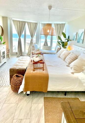 a large bedroom with two beds and a large window at Oversized condo Beach Oasis 601 Gorgeous Ocean front with spectacular views in Daytona Beach