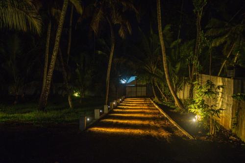 a pathway leading to a house at night at Villa Greenjay Ahangama in Ahangama