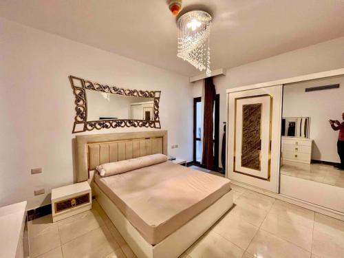 a bedroom with a large bed and a large mirror at UNIQue 2BRs LOCation l DOWNTown NEWCairo/City view in Cairo