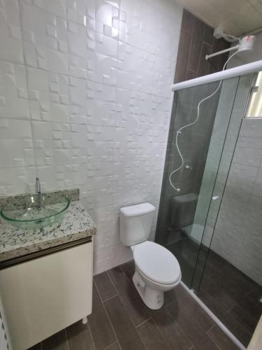 a bathroom with a toilet and a sink and a shower at Vila Verde Container BV in Barra Velha