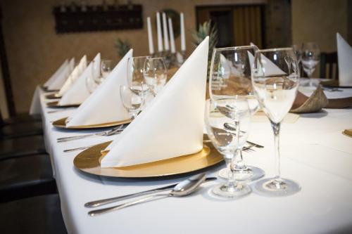 a table with wine glasses and napkins on it at Spree - Waldhotel Cottbus in Cottbus