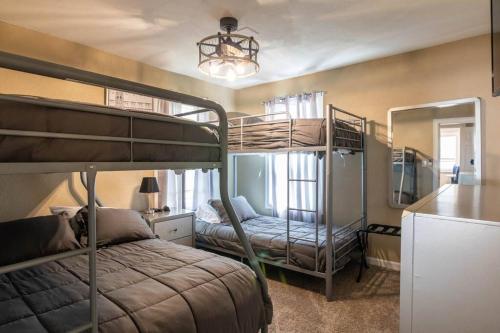 a bedroom with two bunk beds and a mirror at Kickback Parties OK w Smoking Rm 10 minutes to Downtown in Detroit