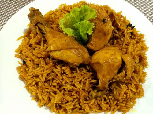 a plate of food with chicken and rice at A Villas Resort & Restaurant in Zamboanguita