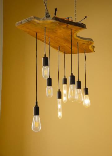 a chandelier with many lights in a room at Lá Homestay in Mỹ Phước