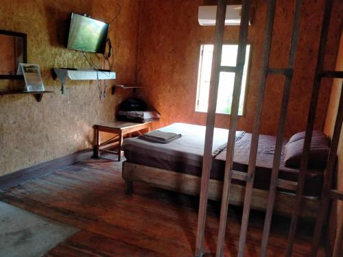 a bedroom with a bunk bed and a window at Sukanyawoodhouse in Ban Tha Rua