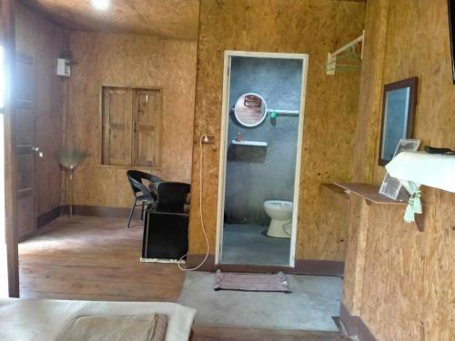 a bathroom with a toilet in a room at Sukanyawoodhouse in Ban Tha Rua