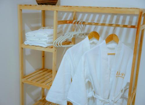 a rack of white towels on a shelf at Lá Homestay in Mỹ Phước