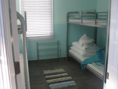 Cette chambre dispose de lits superposés, de serviettes et d'une fenêtre. dans l'établissement Super Cute!! Waterfront Lagoon In Beach Haven West!, à Manahawkin