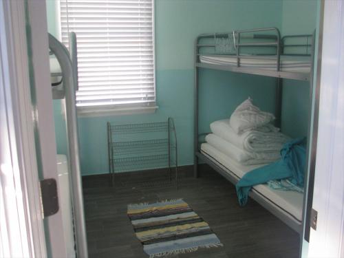 a room with bunk beds with towels and a window at Super Cute!! Waterfront Lagoon In Beach Haven West! in Manahawkin