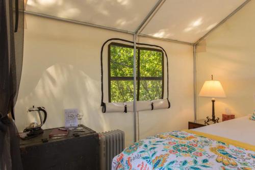 a bedroom with a bed and a window at Beautiful cozy tent in Catskill in Catskill