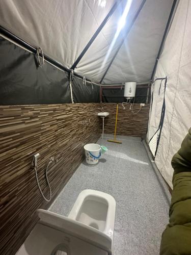 a bathroom with a toilet in a tent at Sari Highlands in Sari