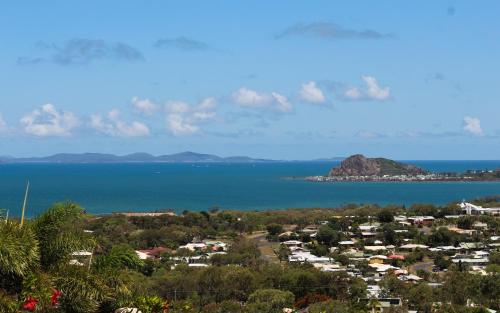 an island in the ocean with houses and a town at Bella Vista - Spectacular Ocean Views & Continental Breakfast in Yeppoon