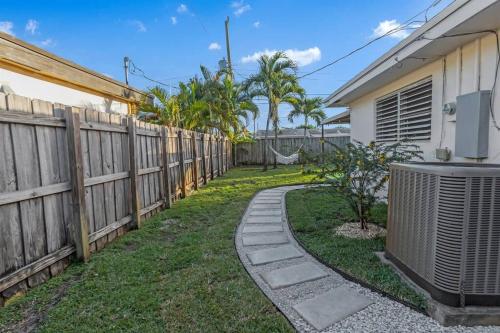 a fence next to a yard with a heater at 7-Person Luxury Spa, Fenced Paradise, Beach Vibes in Pembroke Pines