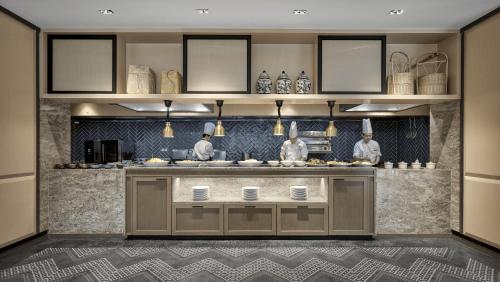 a kitchen with a counter with some food on it at Hyatt Place Kuala Lumpur Bukit Jalil in Kuala Lumpur