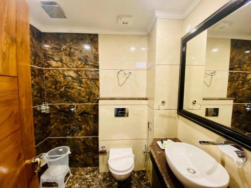 a bathroom with a toilet and a sink at Taarra view green with parking in Gangtok