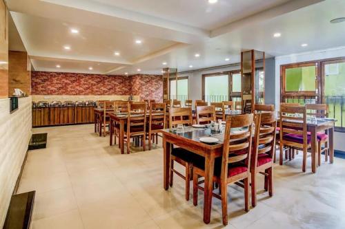 a dining room with wooden tables and chairs at Taarra view green with parking in Gangtok