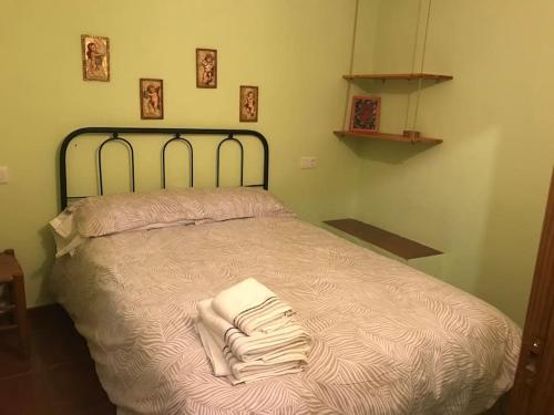 a bedroom with a bed with towels on it at Casa rural Altamira in Portell de Morella