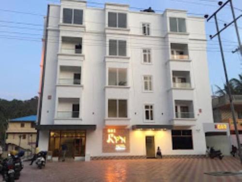 a large white building with a sign on it at Hotel SRI KPN , Austinabad in Austinābād