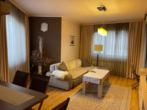 a living room with a couch and a table at Nikol 3 SPA CLUB BOR in Velingrad