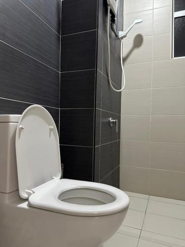 a bathroom with a toilet with the lid up at Manhattan Austin 2-6 pax Family Cozy Suite in Johor Bahru