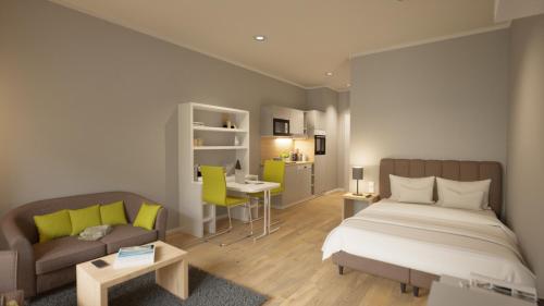 Adapt Apartments Wetzlar في فيتسلار: غرفة نوم بسرير واريكة ومكتب