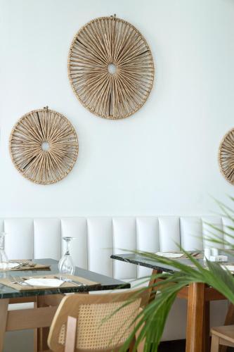 a dining room with a table and three mirrors at Maritimo Beach Hotel in Sissi