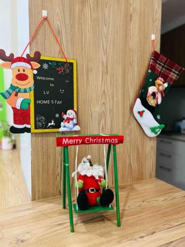 a christmas sign with santa claus and other toys at LV Homestay @ Gala Residence in Kuching