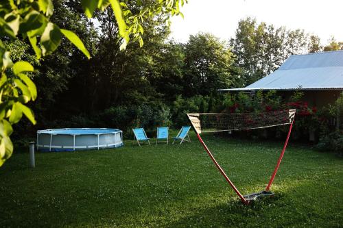 two chairs and a net in a yard at RanczoLatyczyn 