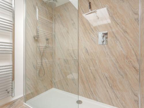 a shower with a glass door in a bathroom at 2 Bed in Bude 66127 in North Tamerton