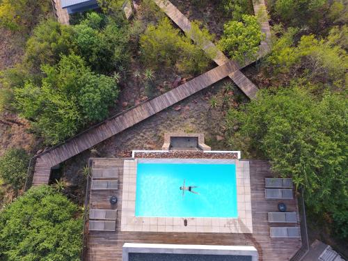 an overhead view of a swimming pool with a person in the water at umVangati House in Hoedspruit