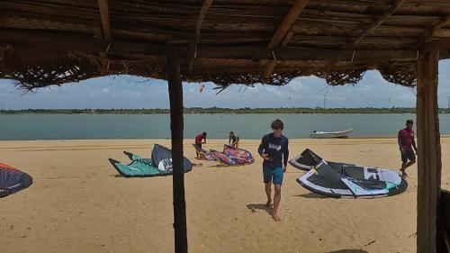 a group of people standing on a beach with kites at Villa Sethawadi Hotel and Kitesurf Centre in Kalpitiya
