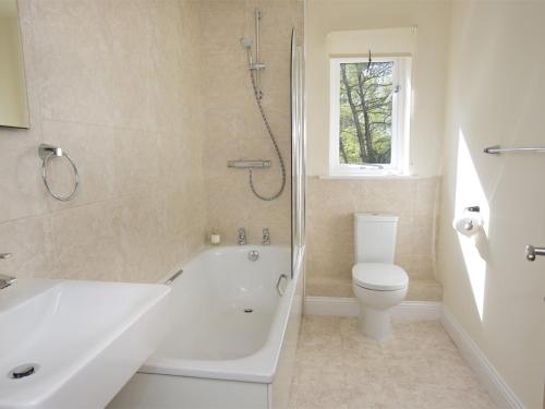 a bathroom with a tub and a toilet and a shower at 3 Bed in Bedale G0095 in Crakehall